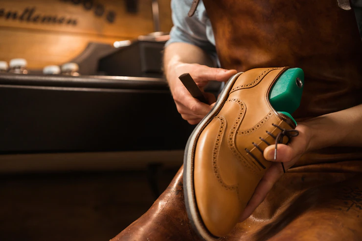 A cobbler repairing shoes
